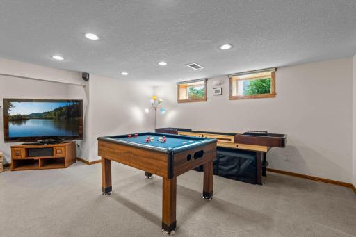 The lower level also includes a game room with space for a pool table and shuffleboard, perfect for entertaining.