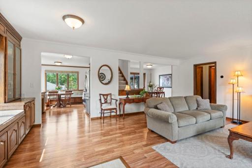 The living room opens through to the dining area and kitchen, showcasing the home's connected main-level layout.