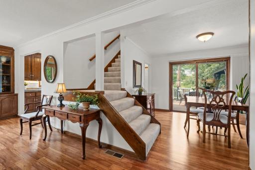 The staircase to the upper level sits just steps from the dining area, with sliding doors leading out to the deck.