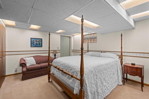The lower level's fifth bedroom offers a comfortable retreat, ideal for guests or a mother-in-law suite.