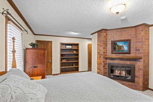 Built-in shelving and a private electric fireplace make this a true primary suite retreat.