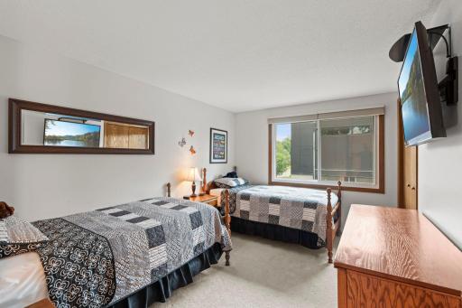 A bright secondary bedroom comfortably fits two beds, perfect for kids or guests.
