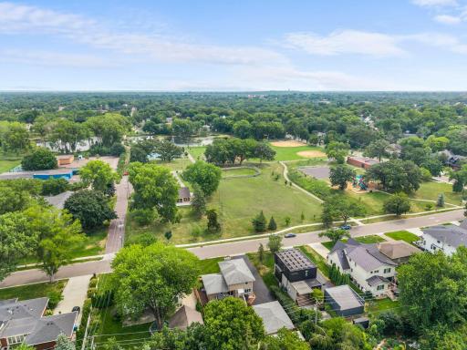 This sweeping aerial view shows Weber Park's pond, ball field, and playground, all within view of this Morningside home.