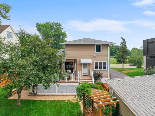 This angle highlights the home's classic architecture and mature landscaping from the back corner of the lot.