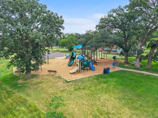 Weber Park's shaded playground, tucked under mature oaks, is just across the street from the home.