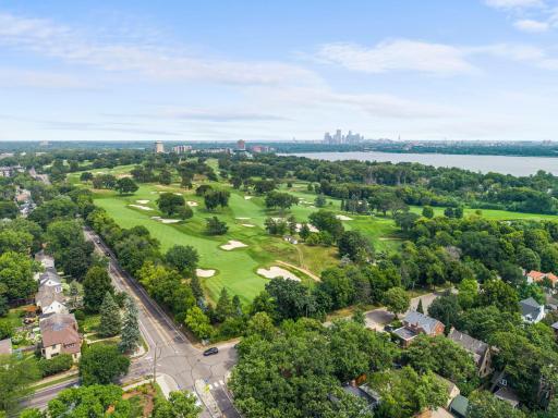 This scenic aerial captures the nearby golf course, lake, and downtown skyline that make this Edina location so desirable.