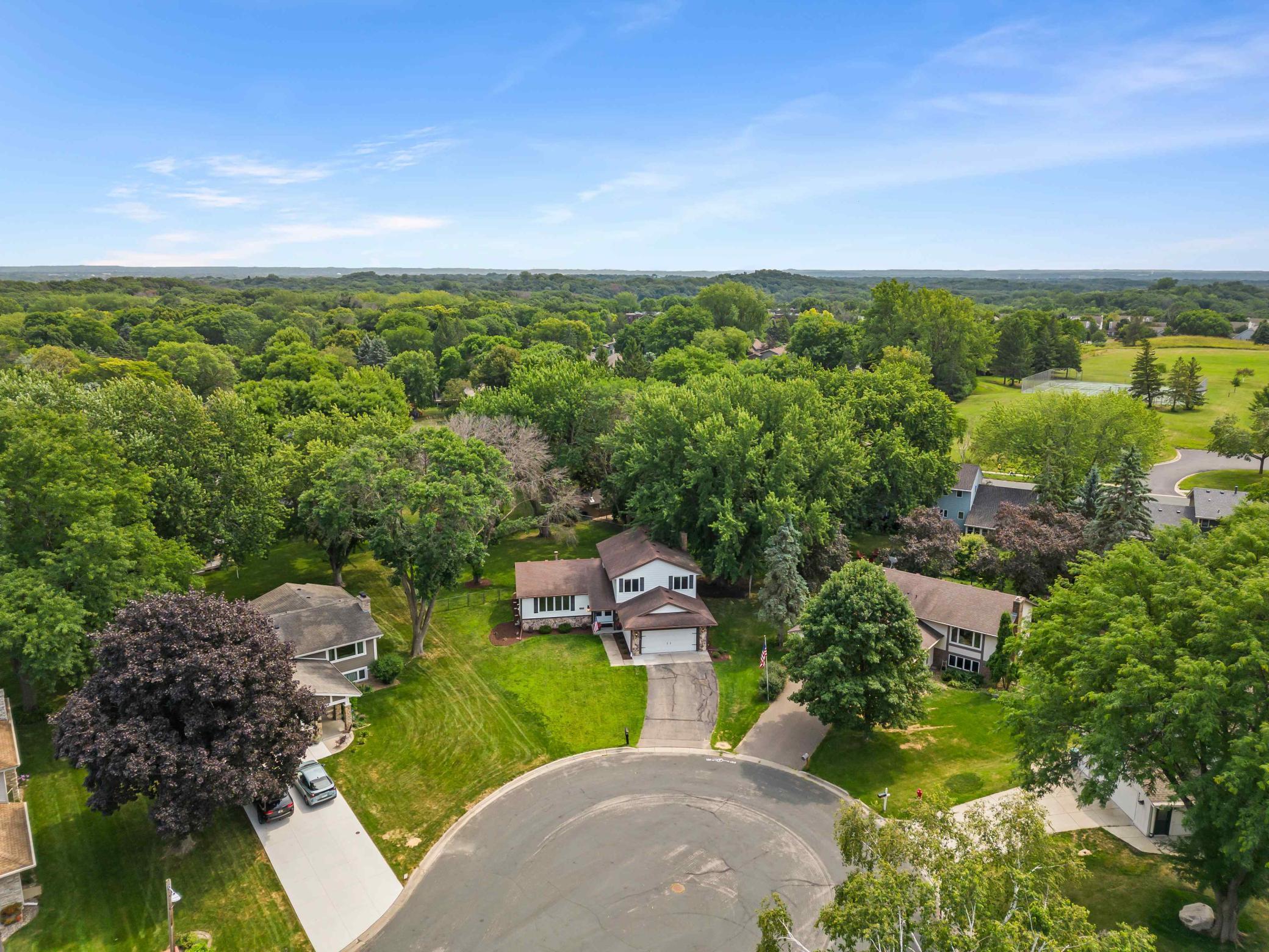 Tucked into an established neighborhood surrounded by mature trees and green space