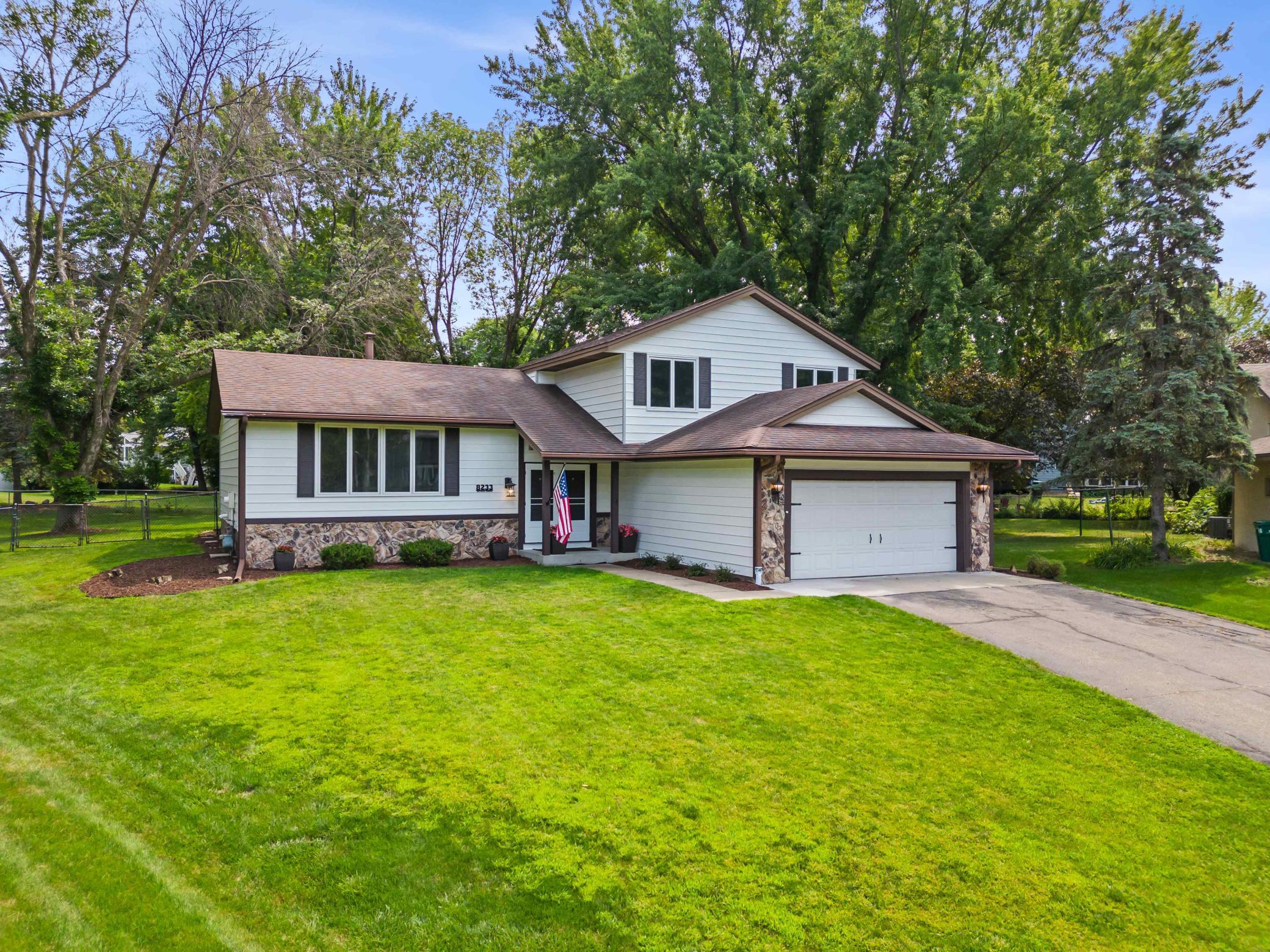 Welcoming curb appeal framed by mature trees and a spacious front lawn