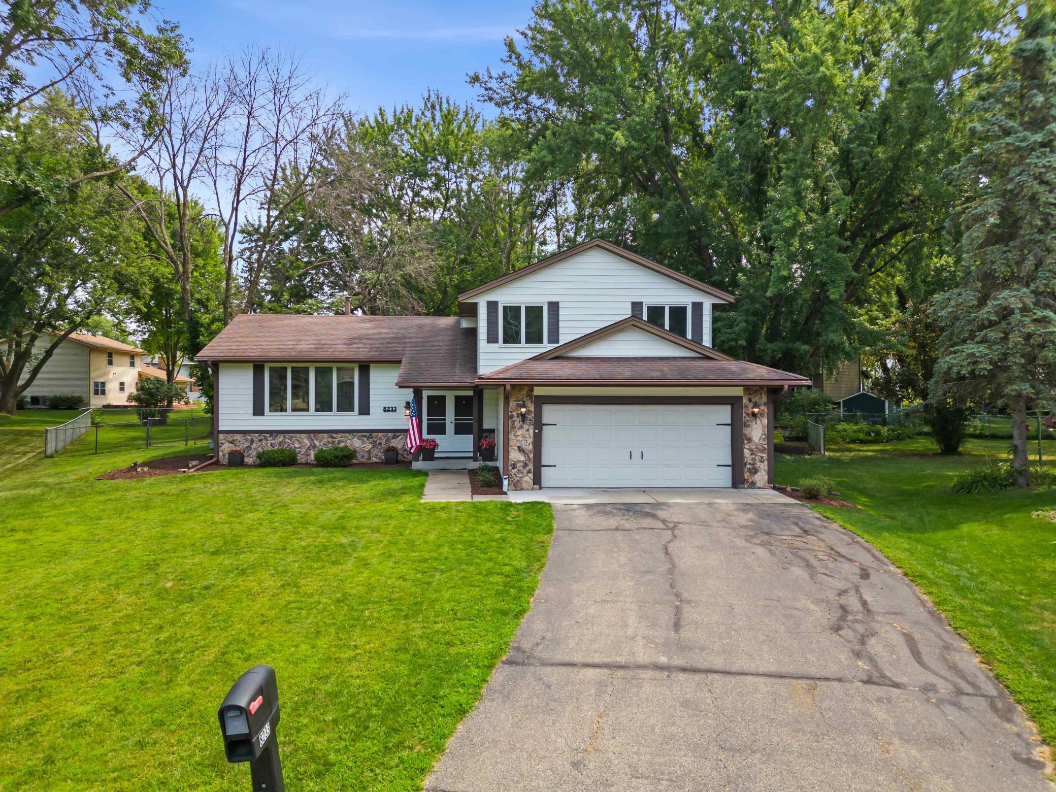 Attractive multi-level home with mature landscaping and an attached two-car garage