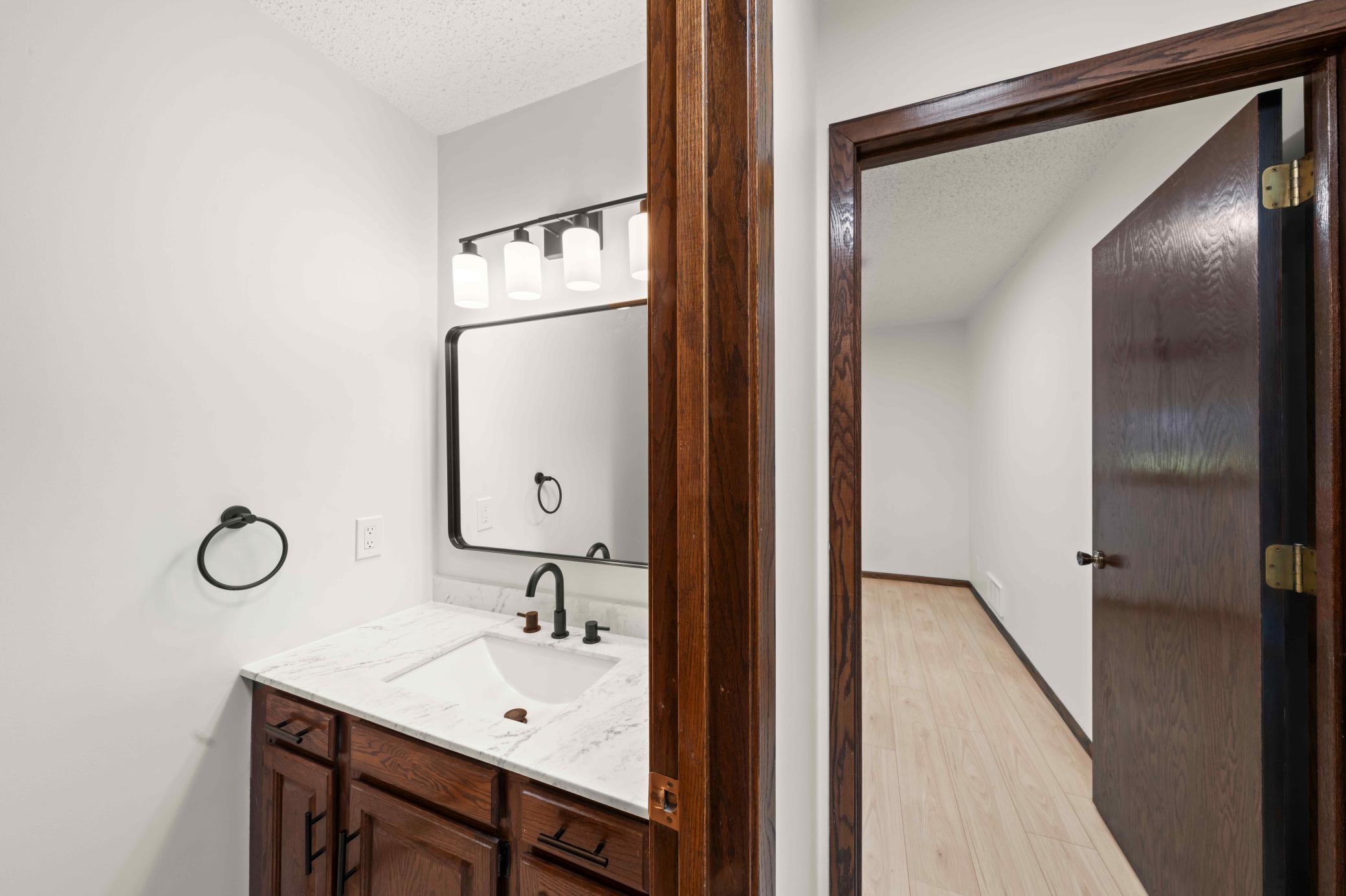 Stylish main-level half bath with updated vanity, fixtures and contemporary finishes