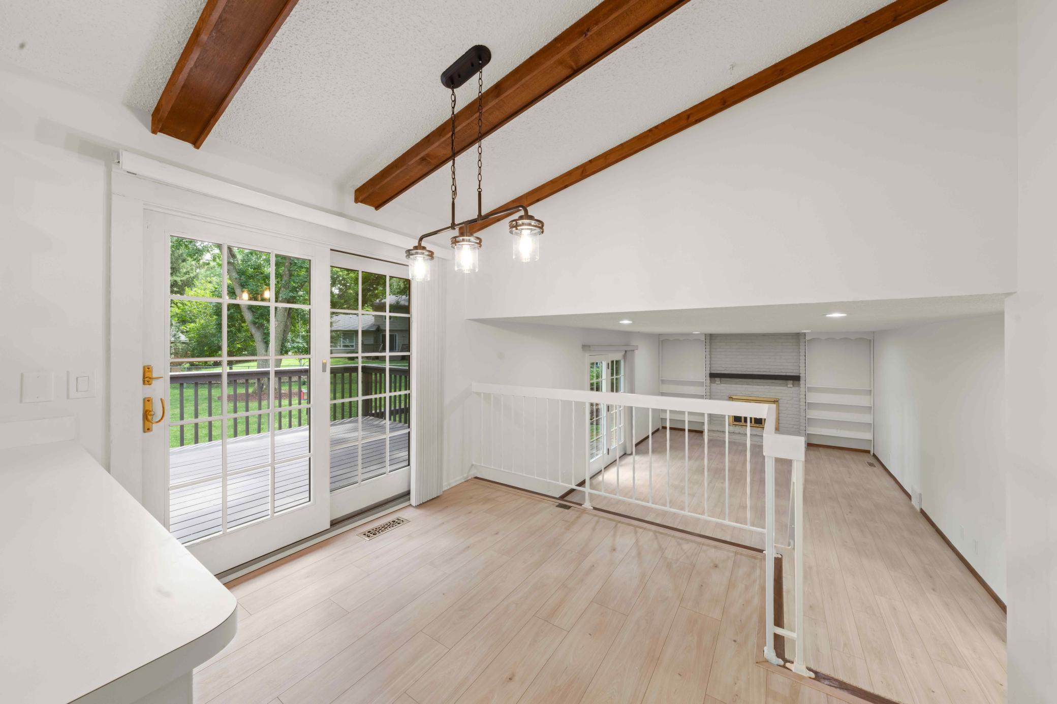 Sun-filled breakfast nook overlooking the family room and opening directly to the deck