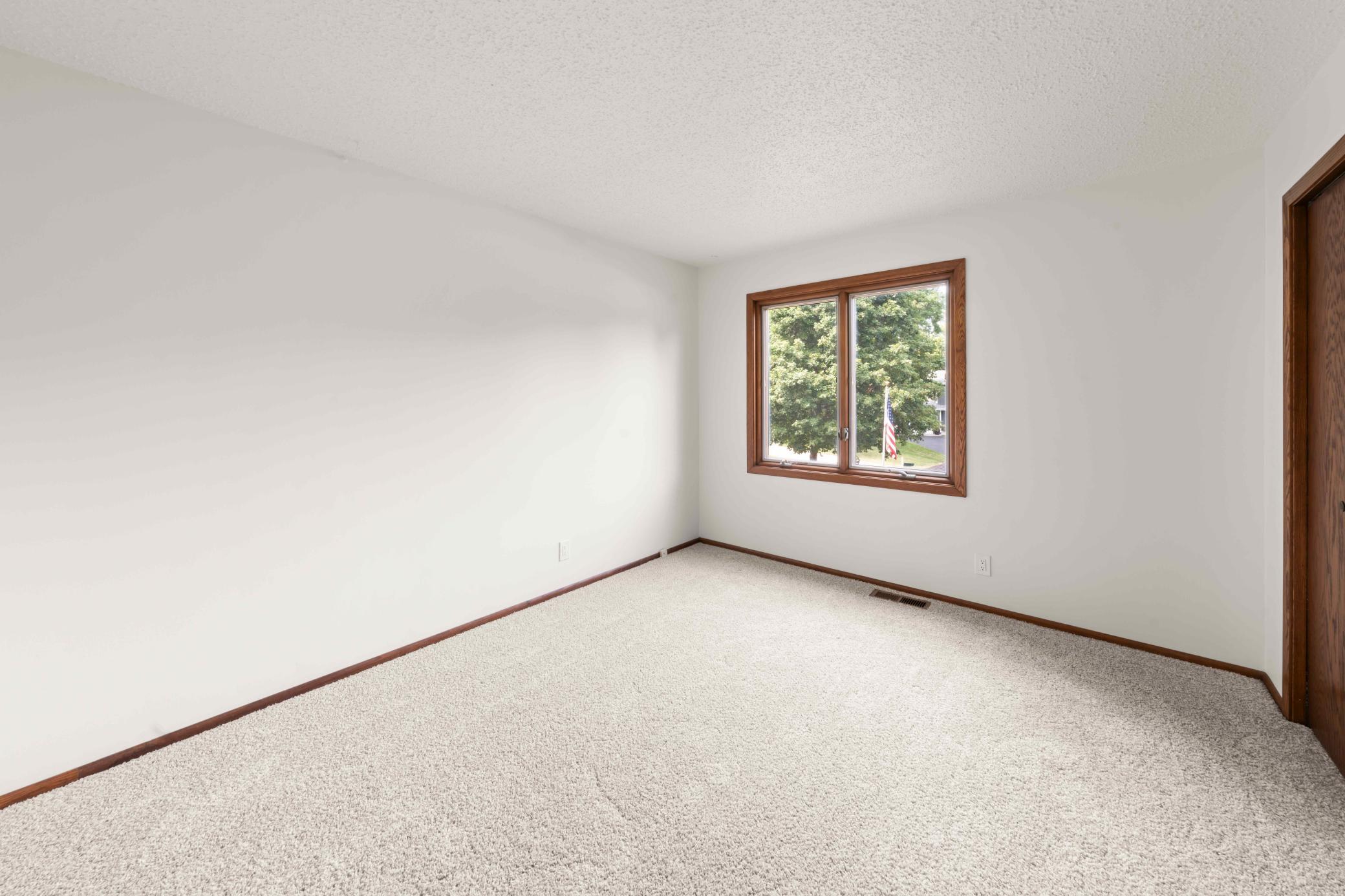 Third bedroom upper-level with new carpeting and natural light from a large window