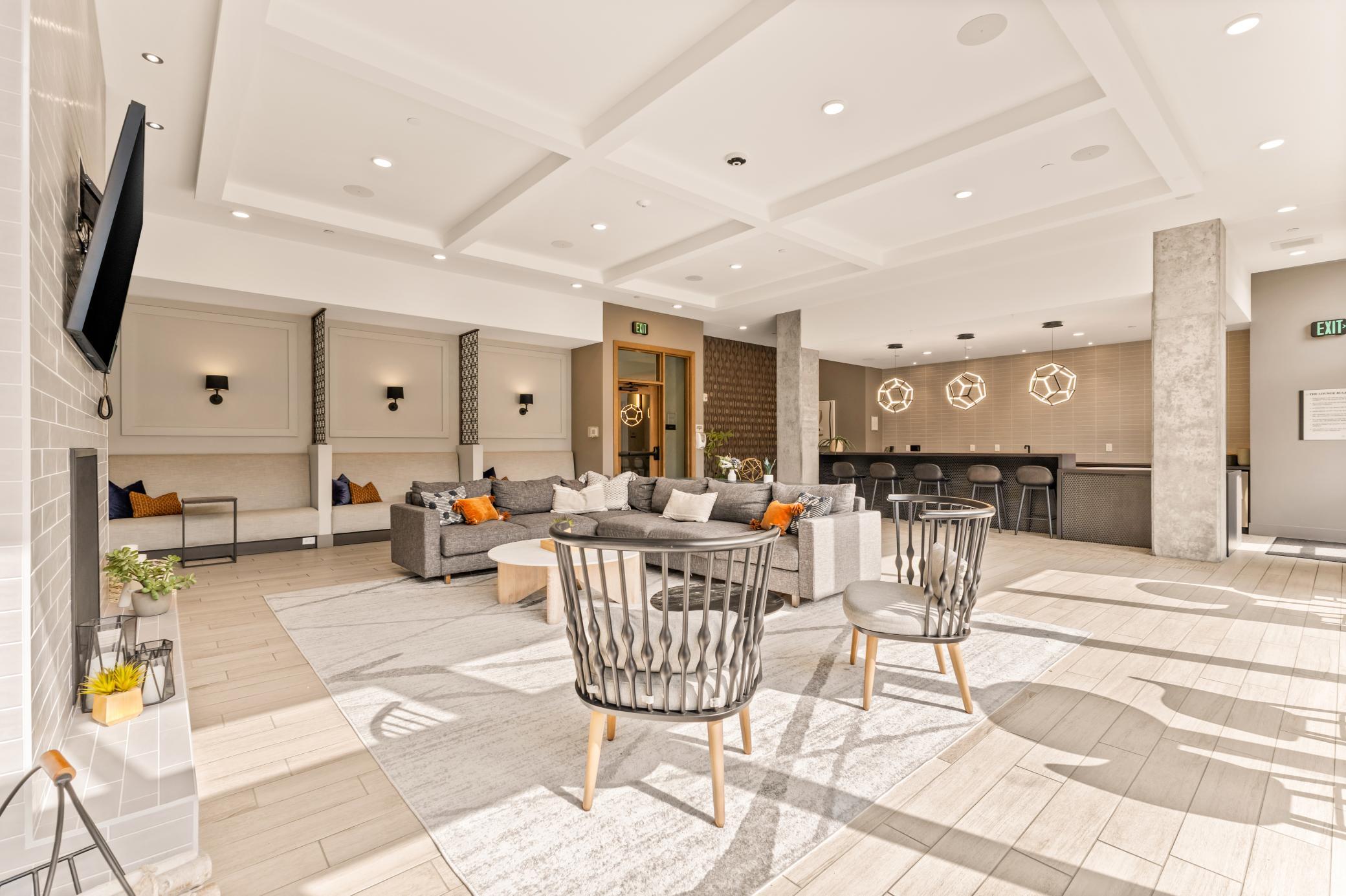 Main Level Community Room with Full Kitchen, Pool Table, Entertainment Space and Bi-Fold Patio Doors to Outside Lounge