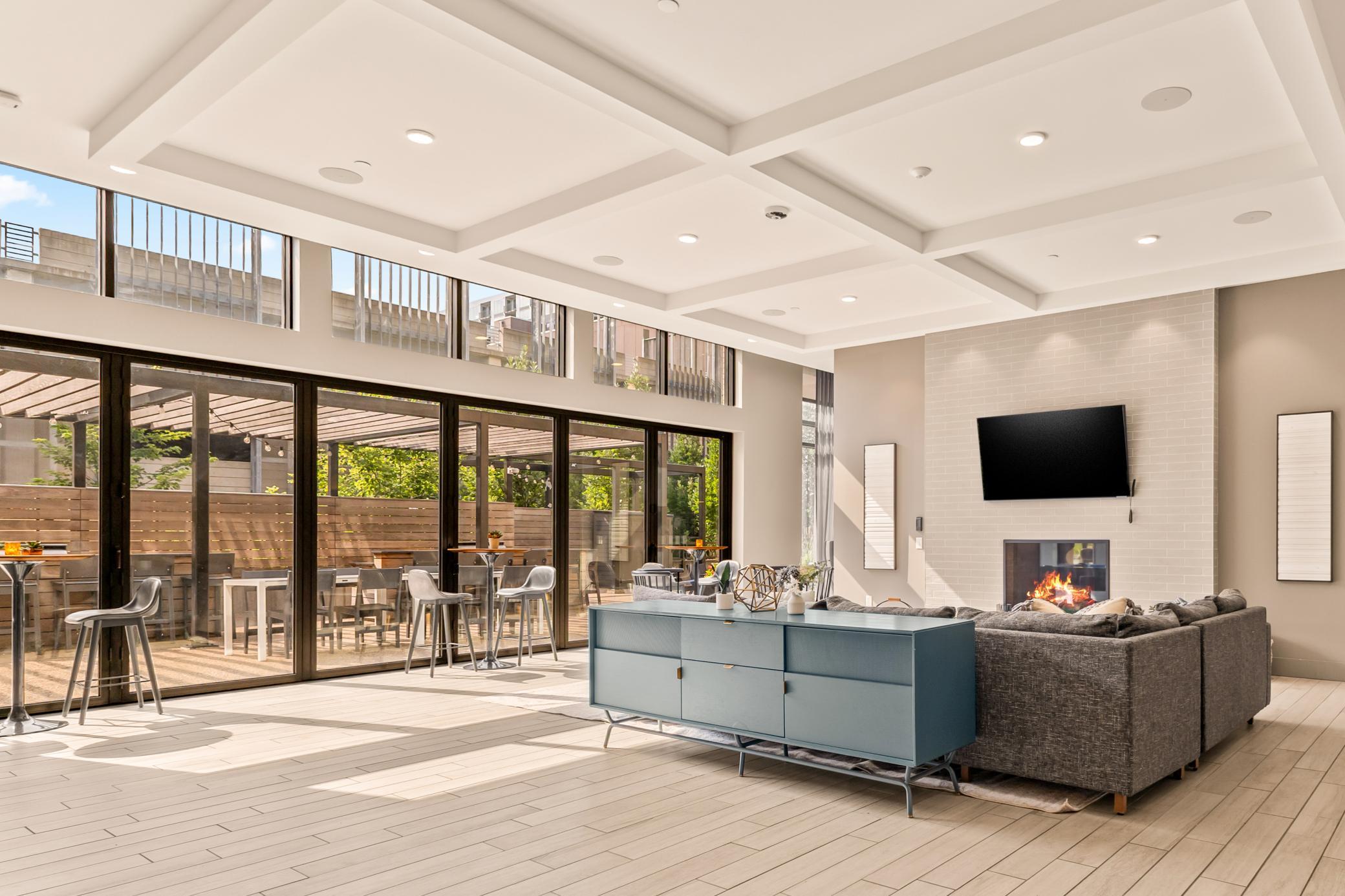 Main Level Community Room with Full Kitchen, Pool Table, Entertainment Space and Bi-Fold Patio Doors to Outside Lounge