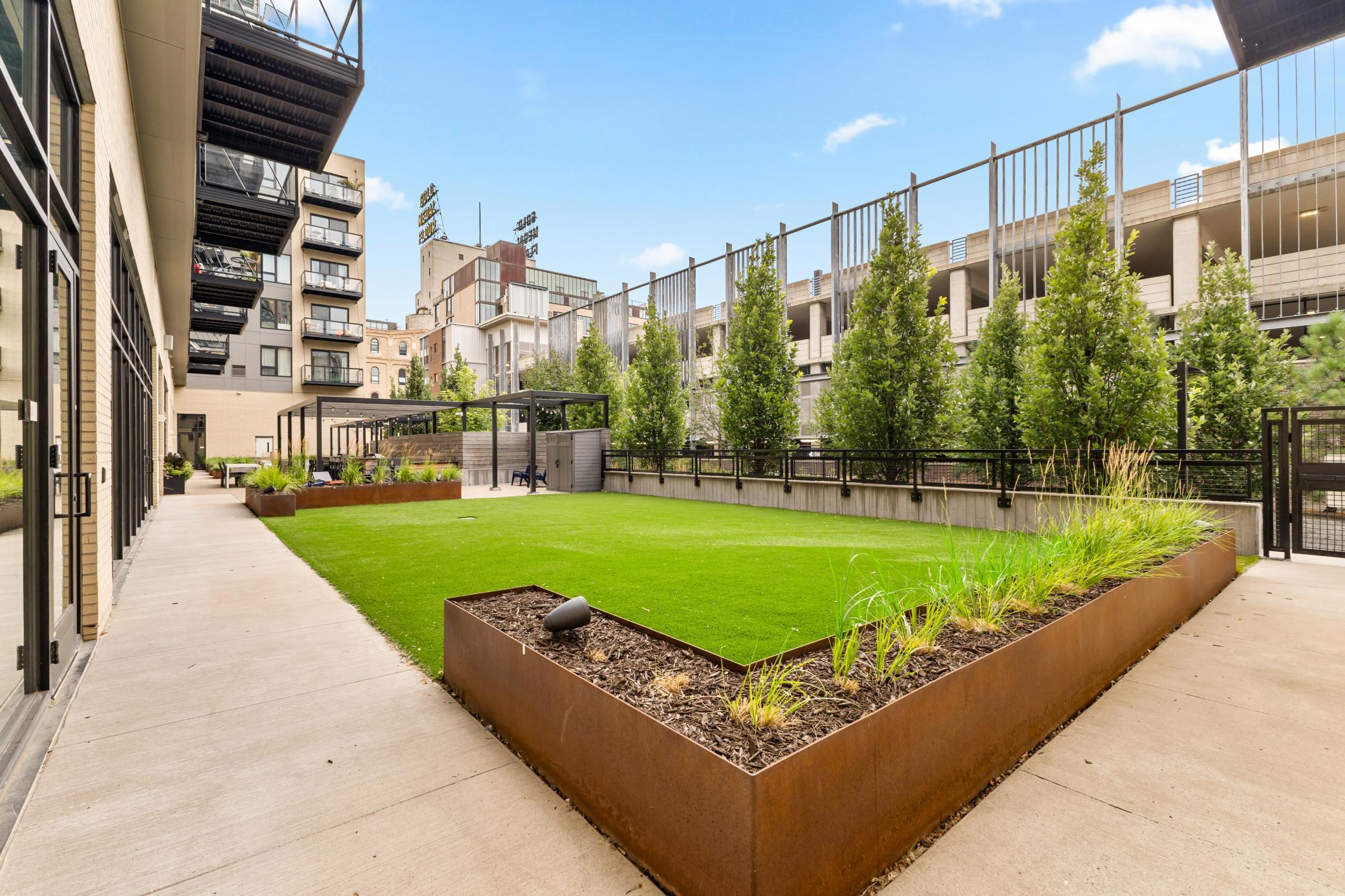 Turf Patio with Outdoor Grills and Lounge Space | Gold Medal Flour Sign View