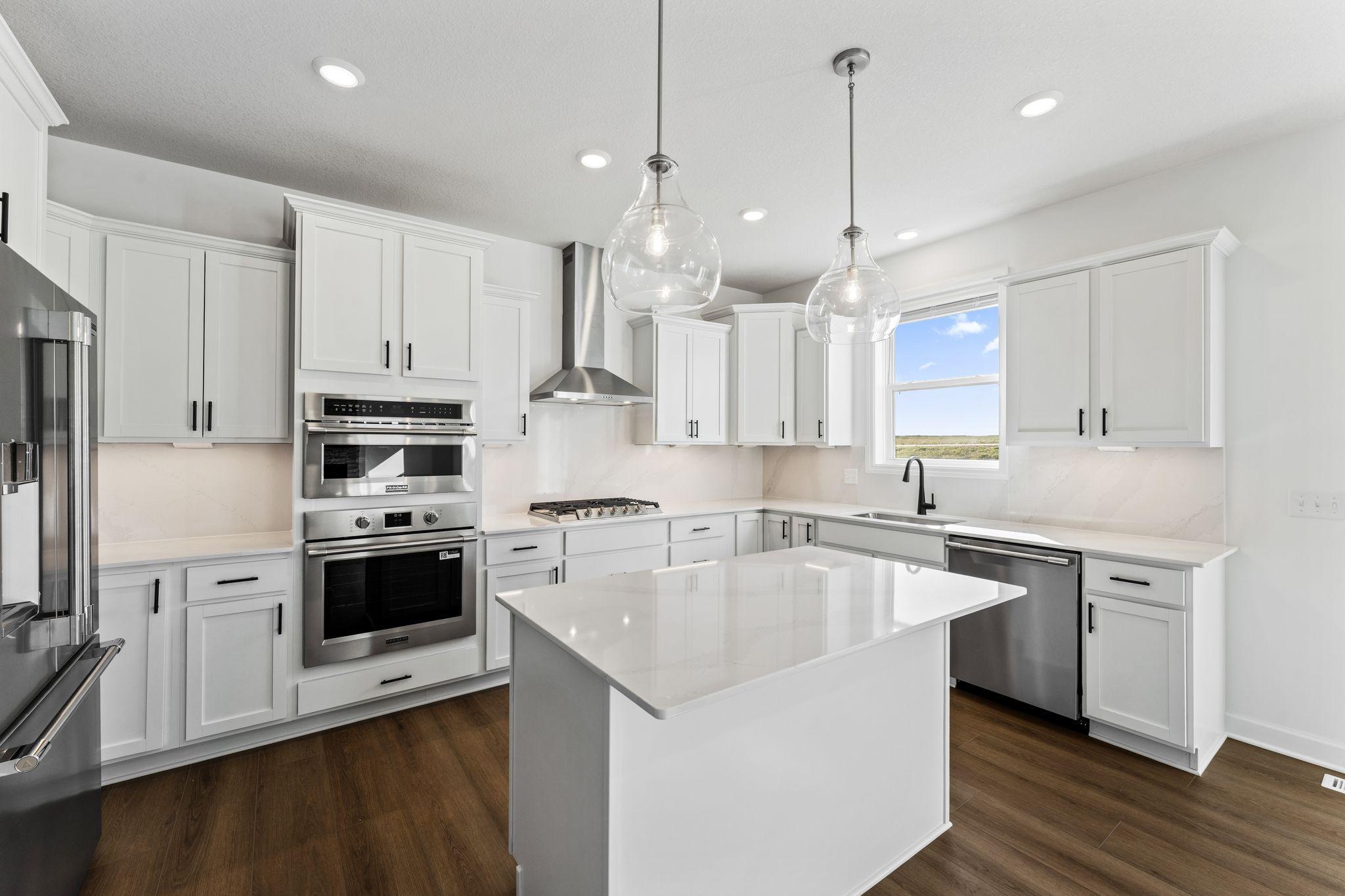 This modern kitchen features a set of brand-new stainless steel appliances, abundant cabinet space and a convenient center island to add seating and counter room.