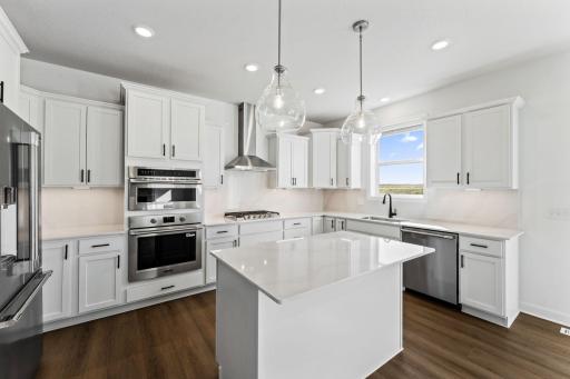 This modern kitchen features a set of brand-new stainless steel appliances, abundant cabinet space and a convenient center island to add seating and counter room.