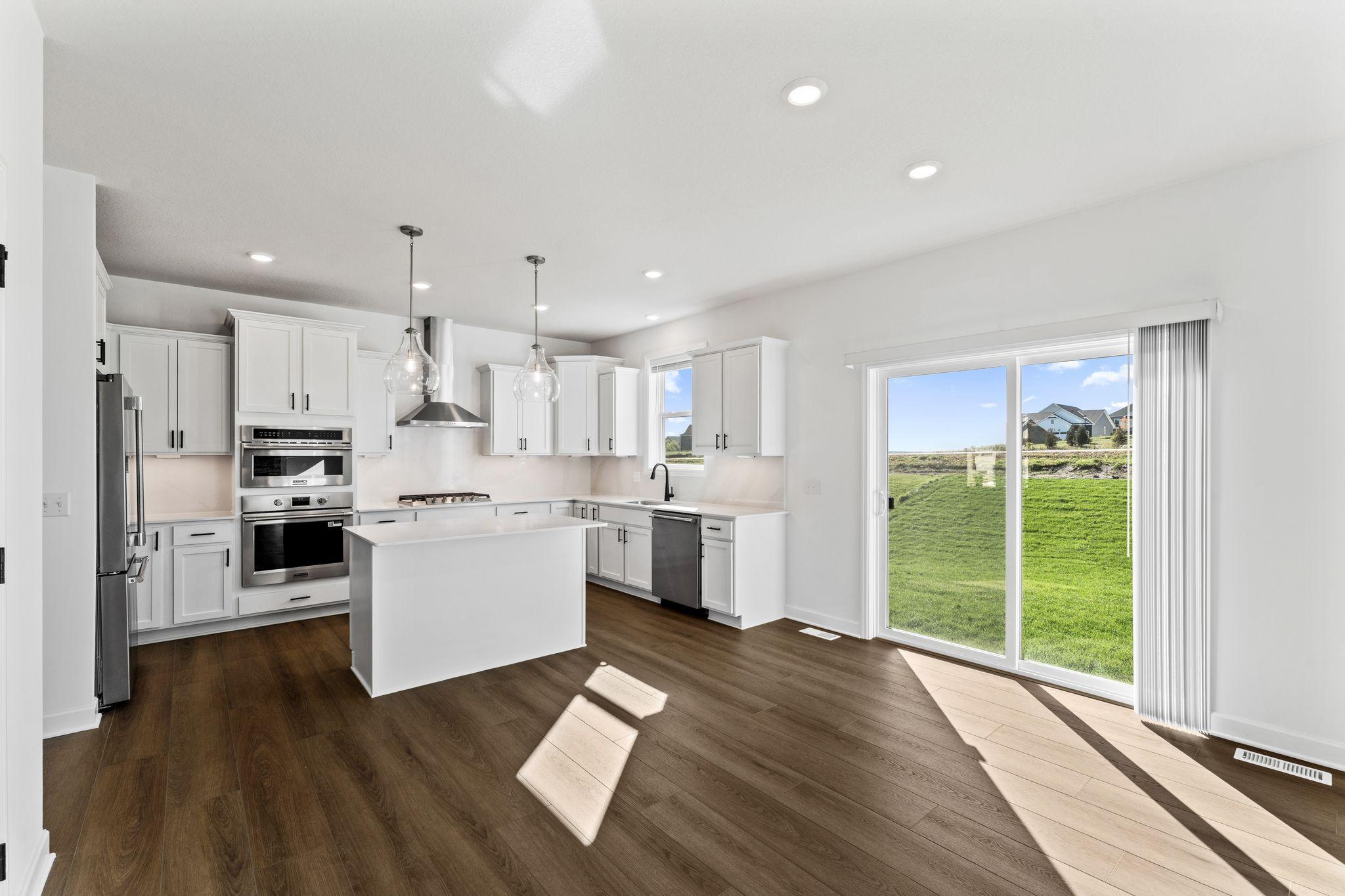 The breakfast room is situated among the open floorplan, allowing for effortless flow between rooms.