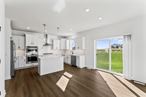 The breakfast room is situated among the open floorplan, allowing for effortless flow between rooms.
