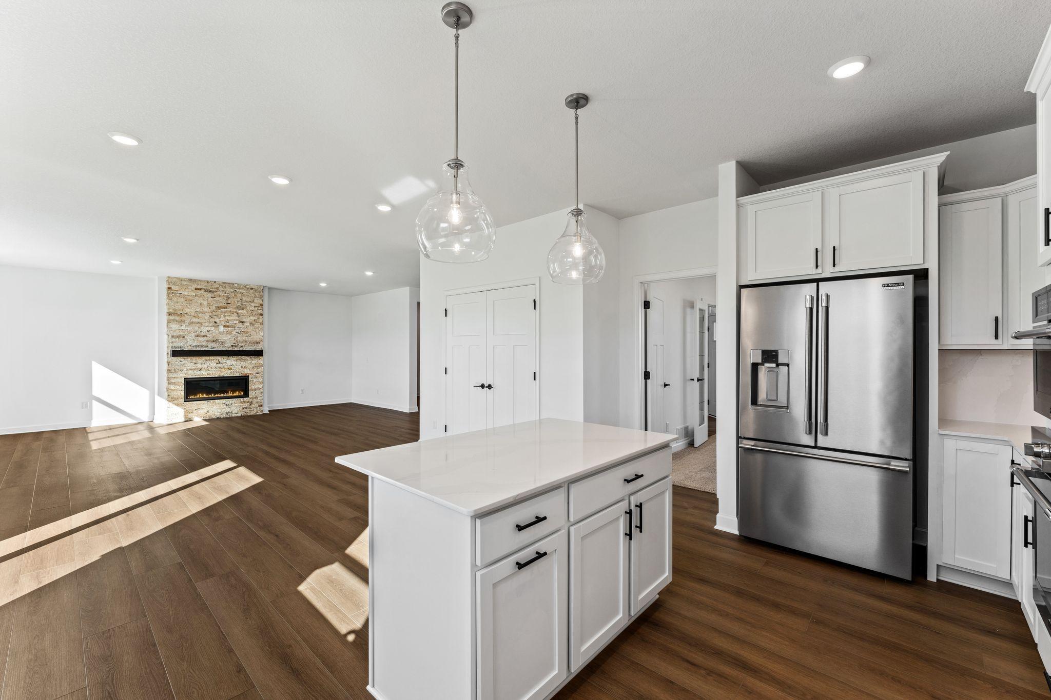 The center island extends out to a breakfast bar for casual meals