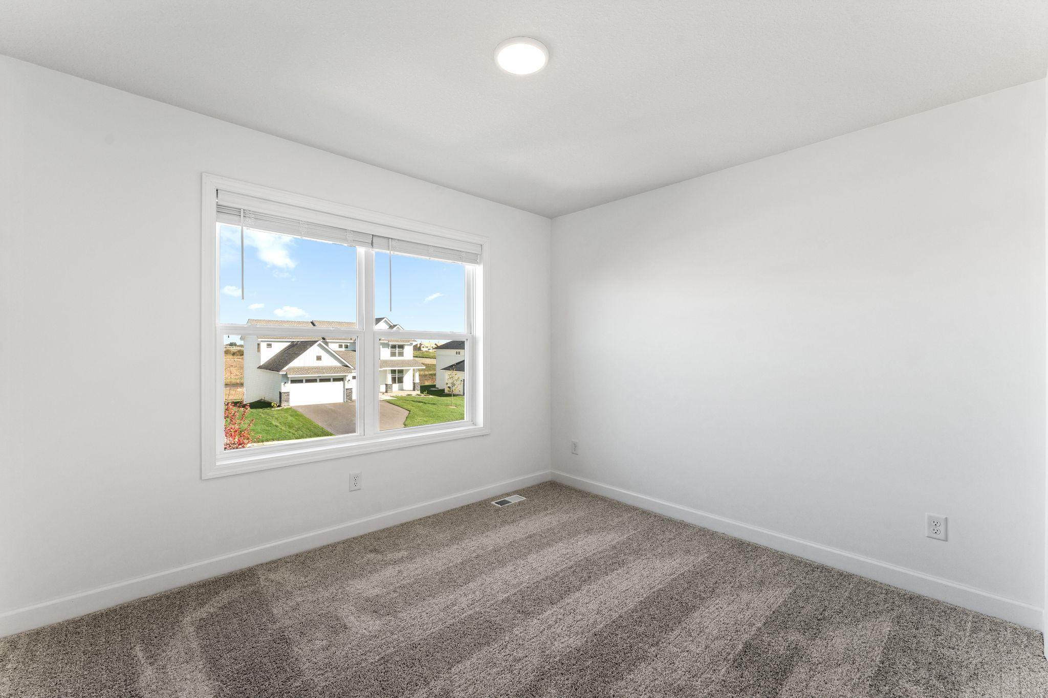 Three secondary bedrooms are located on the second level.