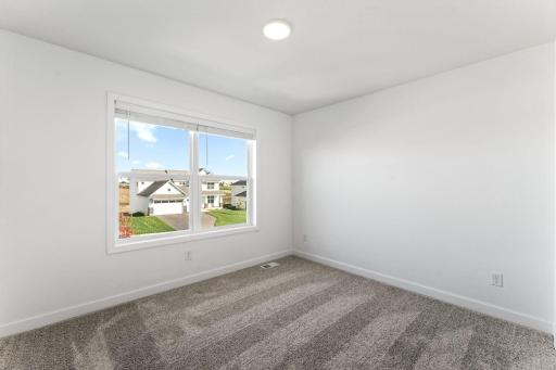 Three secondary bedrooms are located on the second level.