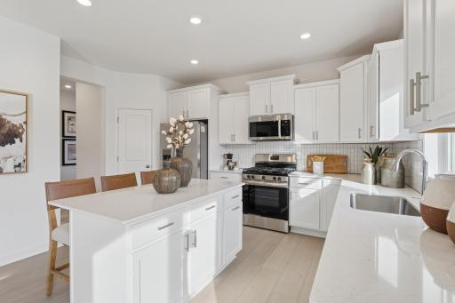 (Photo is of a decorated model, actual homes finishes will vary) Another view of the kitchen.