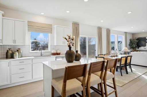 (Photo is of a decorated model, actual homes finishes will vary) The kitchen flows perfectly into the dining room and great room.
