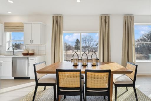 (Photo is of an inventory home, actual homes finishes will vary) Soaked in natural sunlight, the home's eat-in dining room has ample space for a dining table located in the heart of the home.