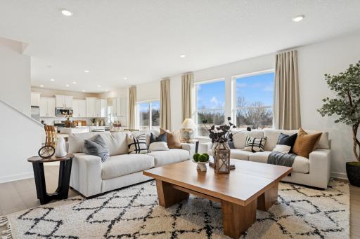 (Photo is of a decorated model, actual homes finishes will vary) An open-concept main level.