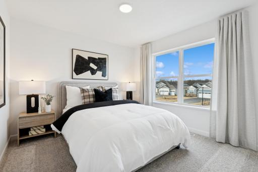 (Photo is of a decorated model, actual homes finishes will vary) The third generously sized secondary bedroom with a spacious walk-in closet.