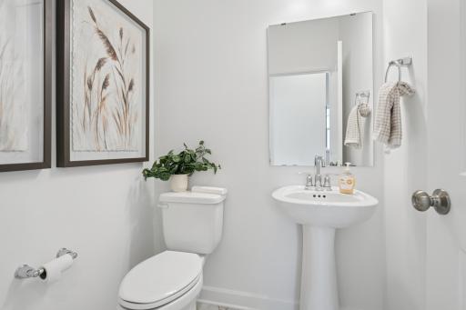 (Photo is of a decorated model, actual homes finishes will vary) Main level powder bath.