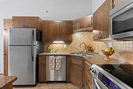 Granite c-tops and backsplash give this kitchen warmth and an updated feel.