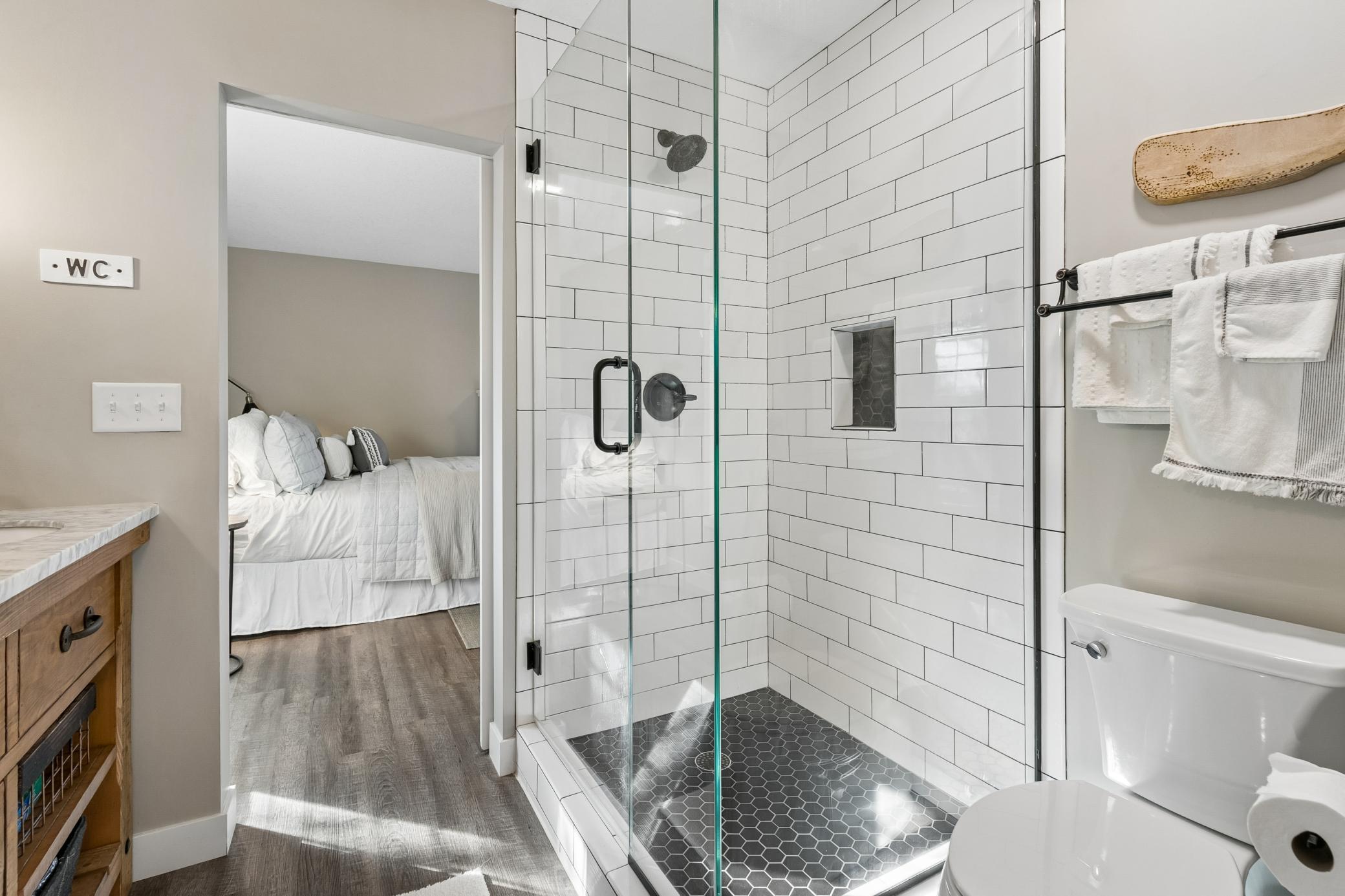 Tiled walk-in glass shower.