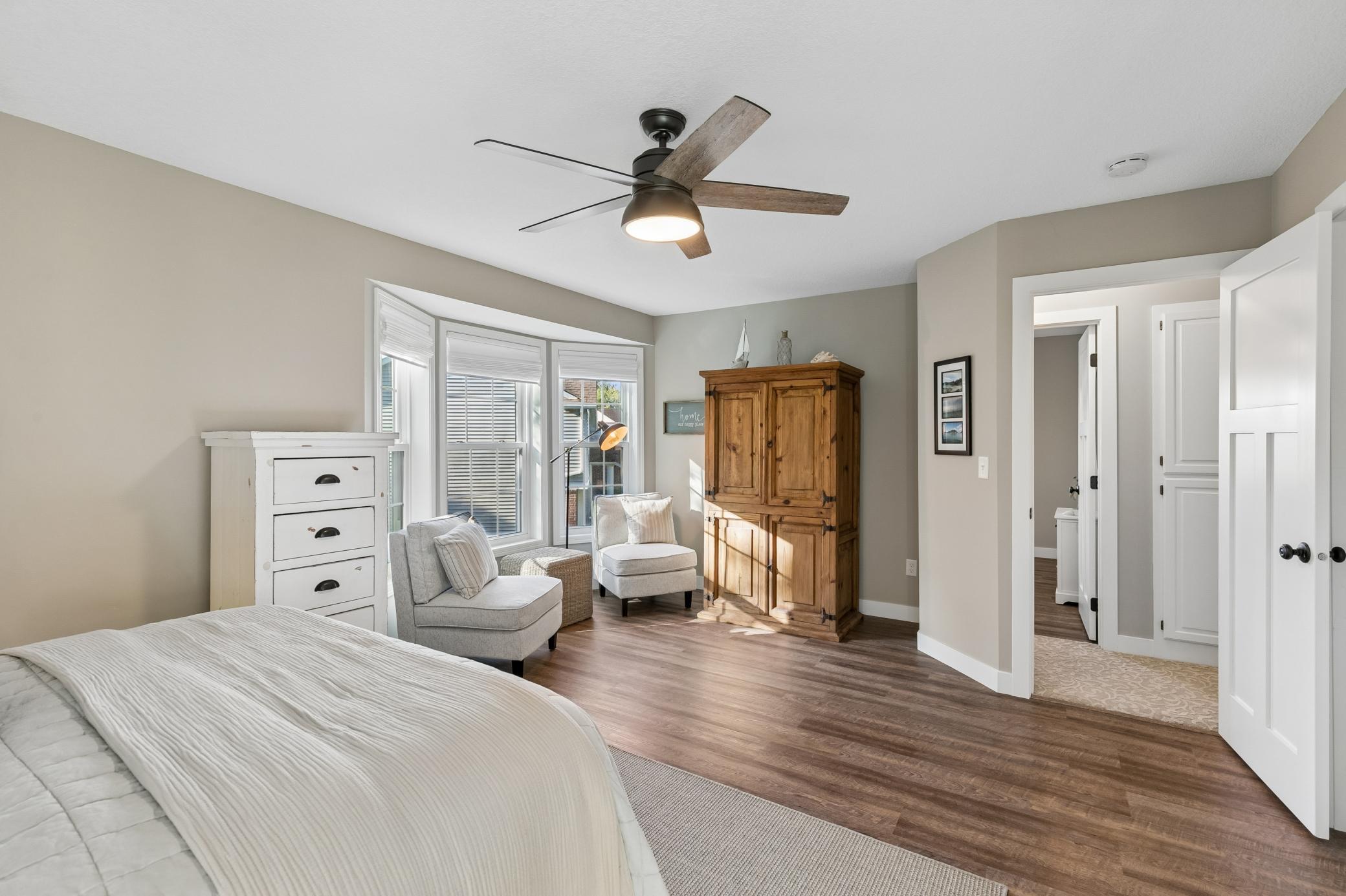 Spacious primary suite features a bay window that fills the room with natural light.
