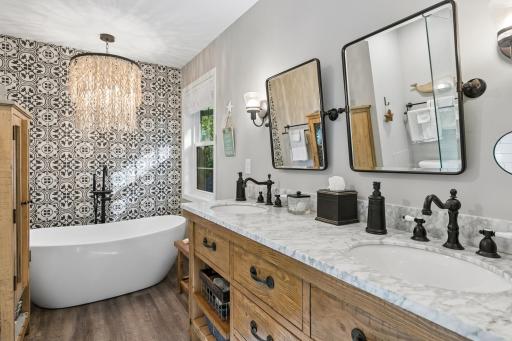 Private primary bath offering dual sinks & a soaking tub.