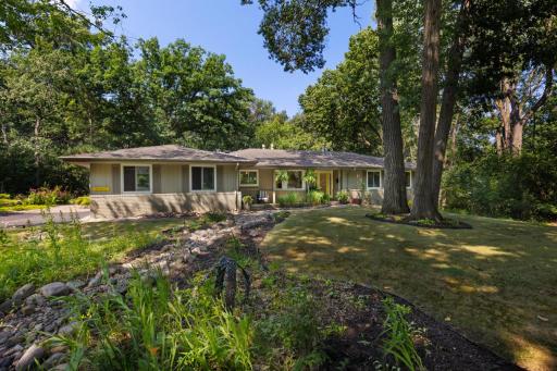 Nestled on a breathtaking 1.15-acre wooded lot in the highly sought-after Forest Haven neighborhood, this exceptional West Bloomington home offers the perfect blend of privacy, tranquility, and convenience.