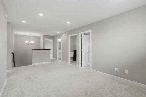 Upper-level loft providing a versatile space that can be used as a reading area, playroom, home office or additional gathering space.