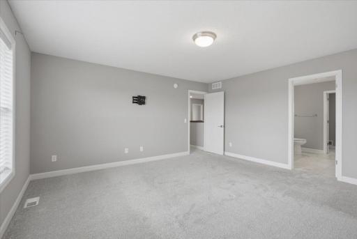 Comfortable primary bedroom featuring a private en-suite.