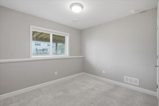 A comfortable lower-level 5th bedroom for family or guests.
