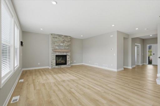 Bright living room filled with natural light and featuring a beautiful fireplace.