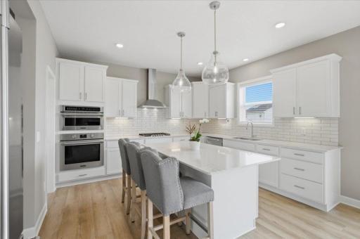 Beautiful kitchen featuring upgraded Frigidaire stainless steel appliances, granite countertops and plenty of workspace for cooking and entertaining.