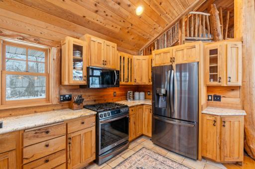 kitchen w custom cabinets and SS appliances