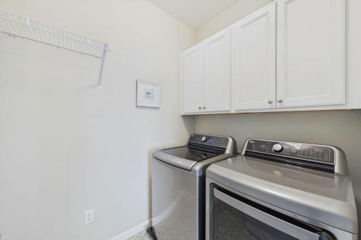 Laundry room with custom cabinets and hanging racking
