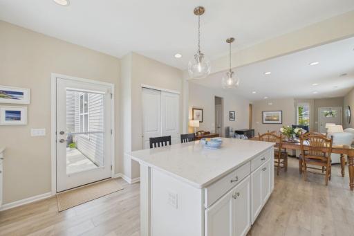 Spacious kitchen with oversized island with breakfast bar. Leading out to beautiful back patio overlooking backyard & pond.
