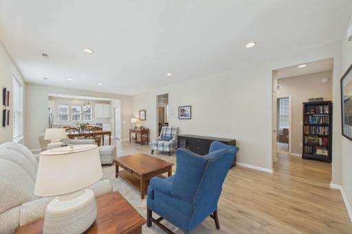 Entry of home leading to open concept living room, tall ceilings, recessed LED lighting, upgraded flooring and upgraded window treatments.