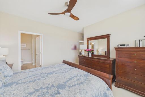 Spacious primary bedroom (18.3x13), large windows for natural sunlight, large walk in closet, decorative ceiling fan