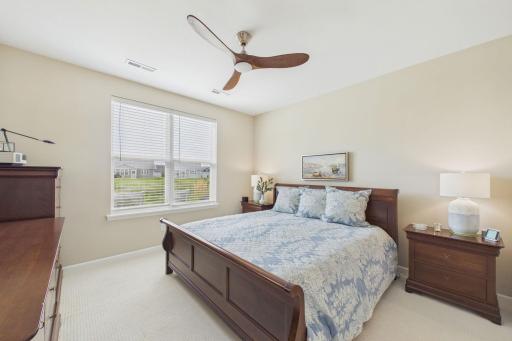 Spacious primary bedroom (18.3x13), large windows for natural sunlight, large walk in closet, decorative ceiling fan.