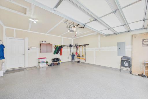 Spacious garage (20.5x18) with epoxy flooring, additional side shop area (9x6.5).