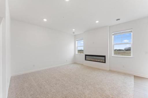 (Photo of a similar home, actual finishes may vary) The natural gathering space of the home, the Great Room is excellent for hosting movie nights with loved ones with an electric fireplace to add a warm charm.